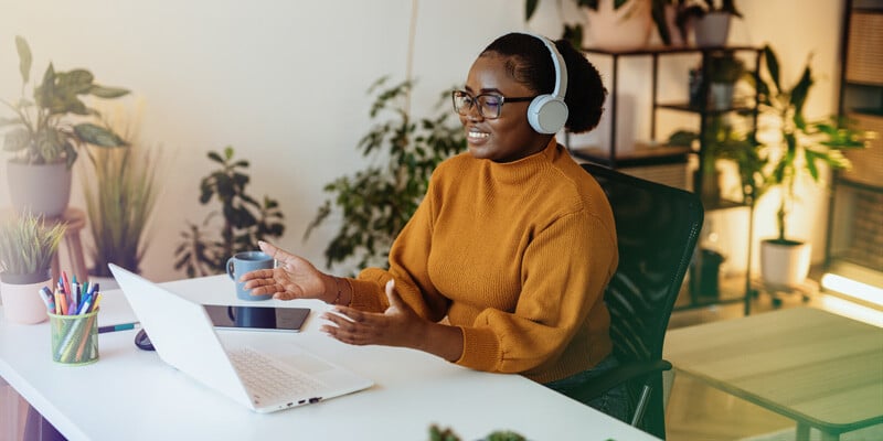 Female small business owner sitting at her laptop using virtual meeting tips
