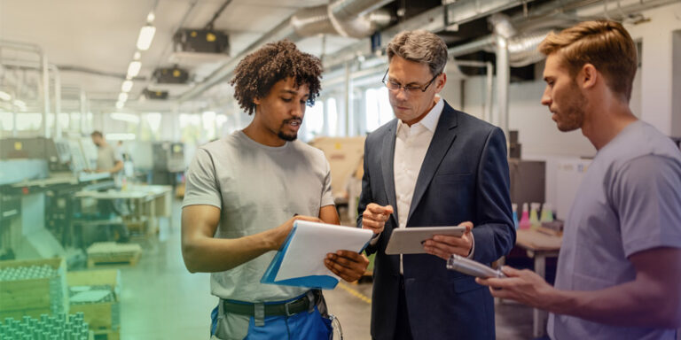 A male business owner discussing his business resilience plan with his workers.