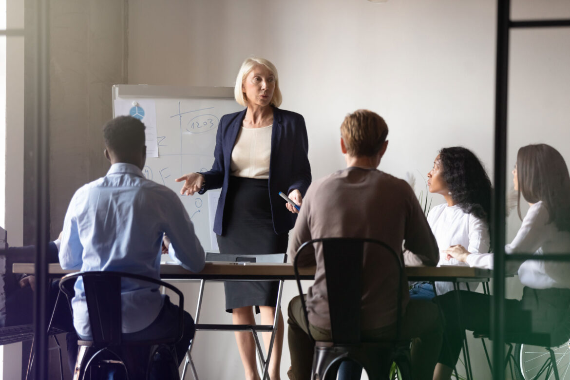 A business owner is presenting in front of a group of lenders for a loan syndication.
