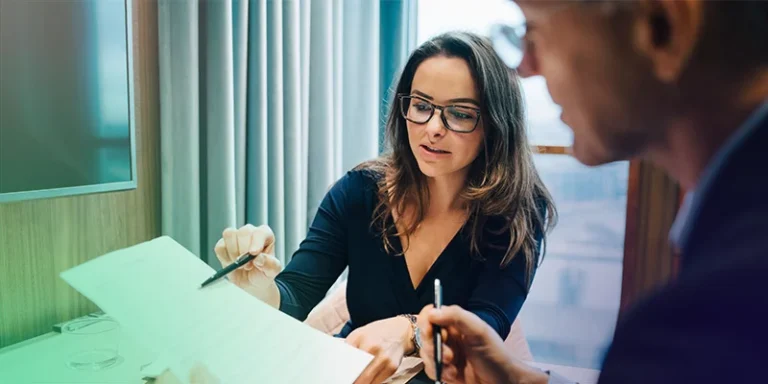 A female loan officer explaining the myths about sba lending to a male small business owner.