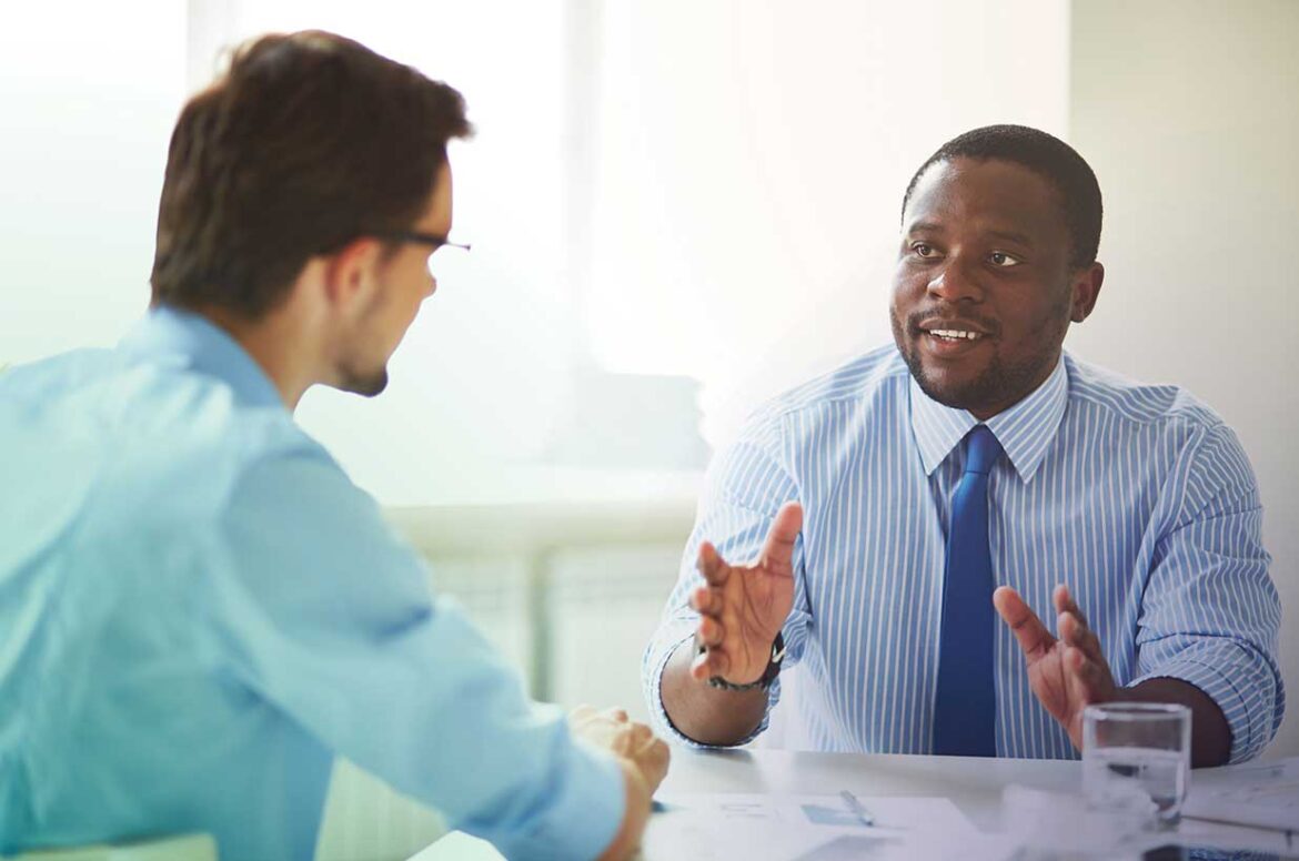 Two male business owners discussing how SBA lenders helped grow their small business.