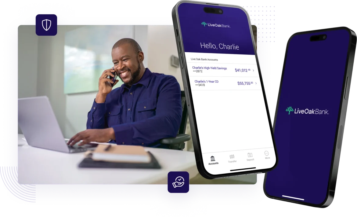 Male sitting at his desk in a home office reviewing his personal banking options while on his phone