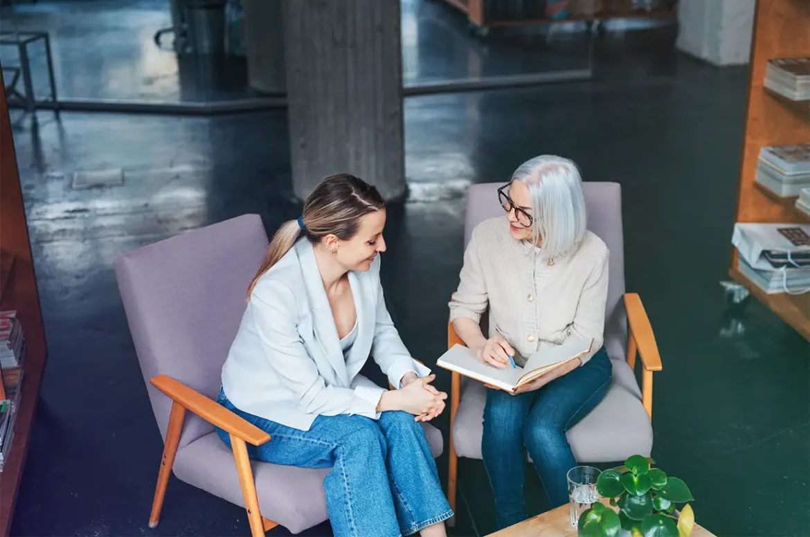 A female bank loan specialist speaking with a female behavioral health care coach about her counseling practice and the opportunity to fund her growing business with a business loan