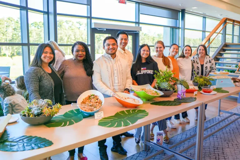 Members of Live Oak Bank's Asian American Pacific Islander Community (AAPIC) employee resource group pose for a group photo during a lunch event to celebrate Filipino American History month