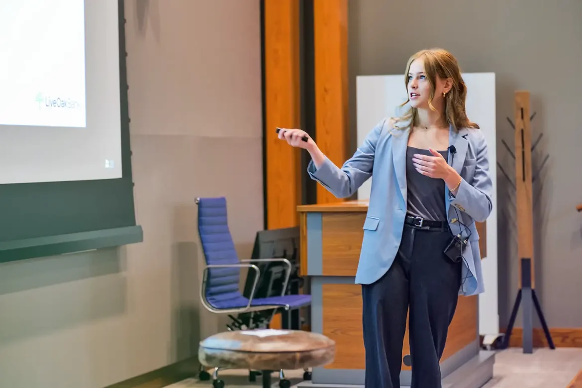 A young female intern at Live Oak Bank presents during an early talent internship program