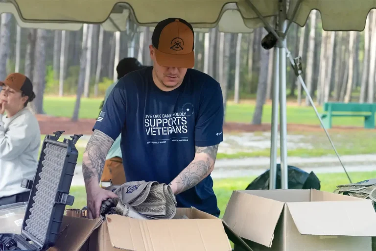 A group of volunteers from Live Oak Bank's veteran empowerment team employee resource group helping set up at the Clays Classic 2025 a veteran sponsored event