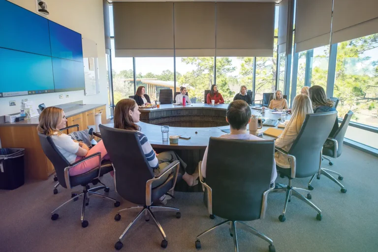 A part of Live Oak Bank's Women Inspired Network employee resource group having a round table meeting on campus to discuss thought leadership and the core values of the company