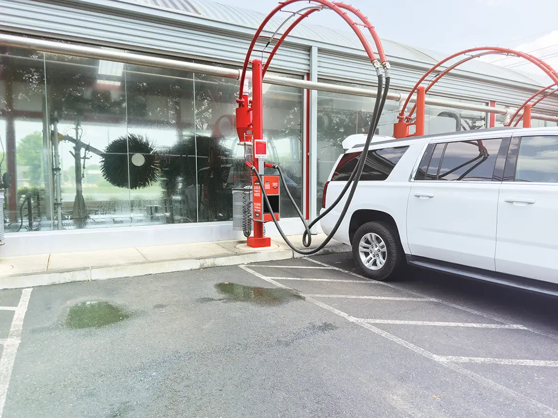 Large white SUV outside of a premium car wash