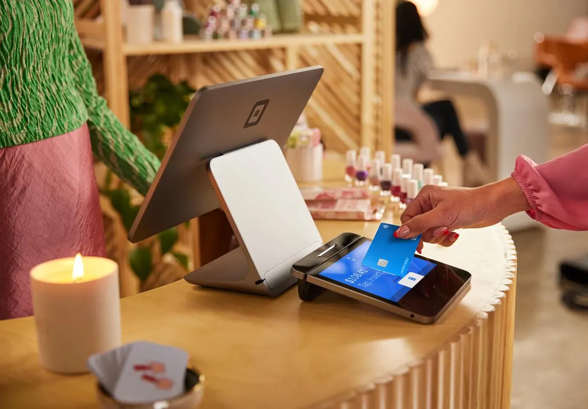 Contactless card payment processed through a modern point-of-sale system at a small business.