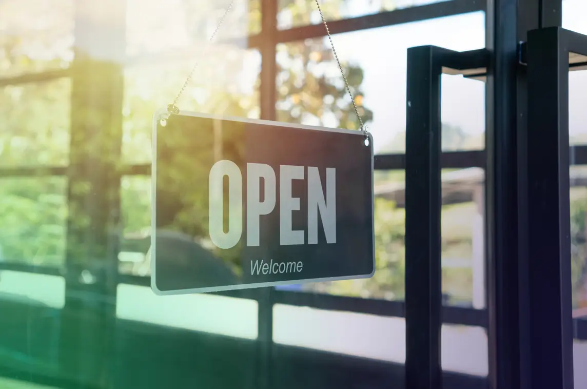 An open sign facing through a business's window